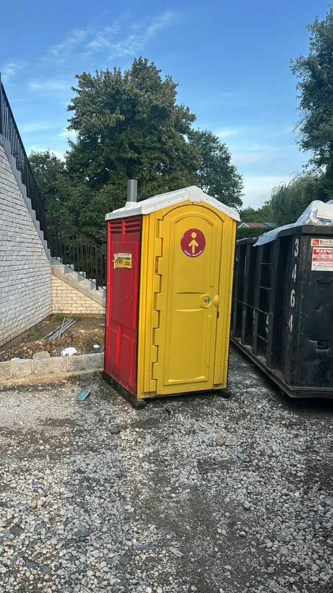 Red and yellow Time2go portable toilet unit ready for an event